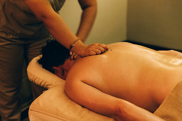 Man relaxing during back massage at the spa
